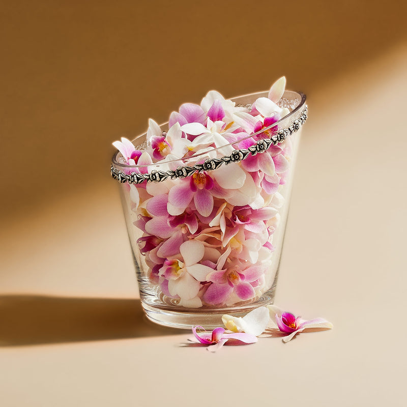 Glass vase with pink and white flowers on a beige background